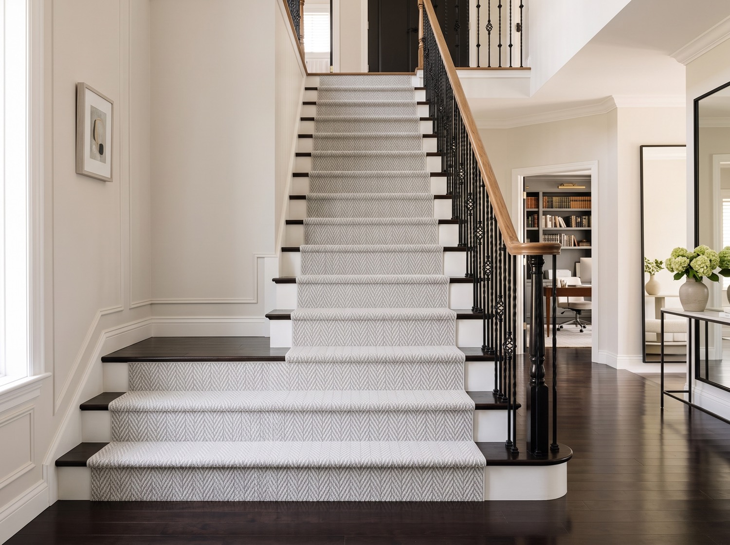 Gray herringbone carpet stair runner installed by Red Carpet in a bright entry