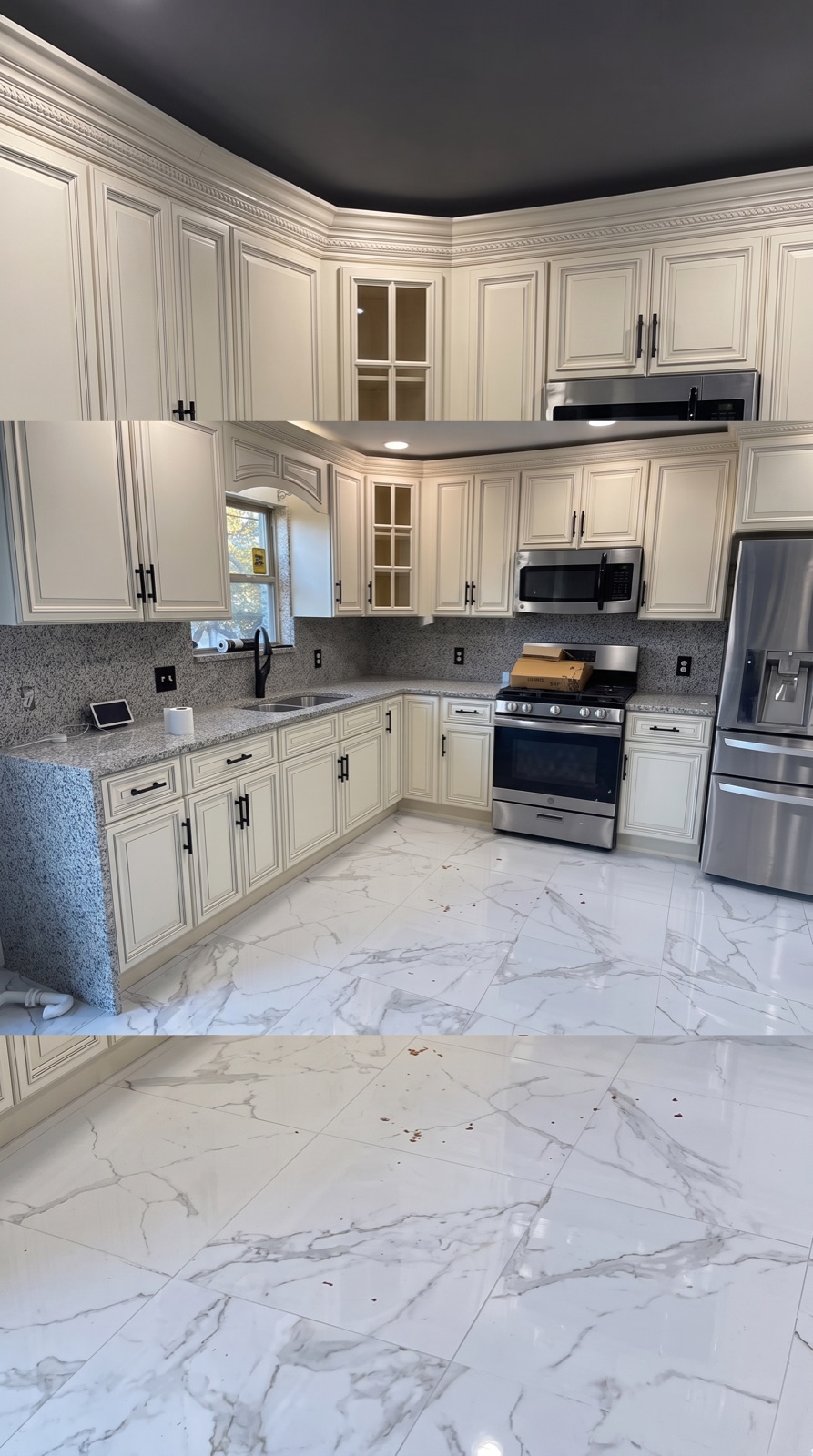 Kitchen with white and gray cabinets, stainless appliances, and marble-look tile floor
